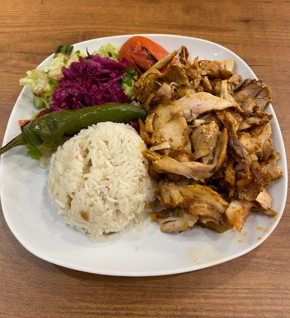 Chicken Gyro · Layers of marinated chicken thighs wrapped around large vertical split and grilled in front of an ingenious herd of charcoal fire. No