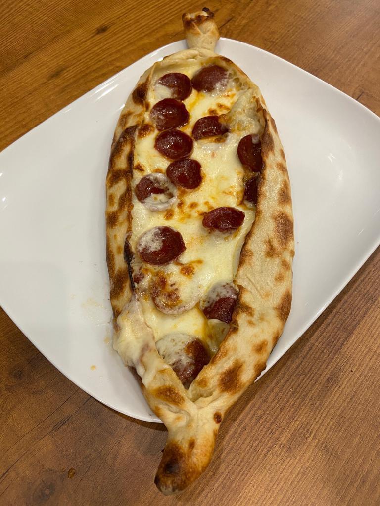 Sausage and Cheese Pide · Sucuklu kasarli pide. A thin crust topped with Turkish sucuk (sausage) and mozzarella cheese.