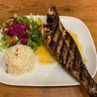 Chargrilled Branzini · Exotic flaky, white sweet meat. Ordered as a whole served with salad and rice.