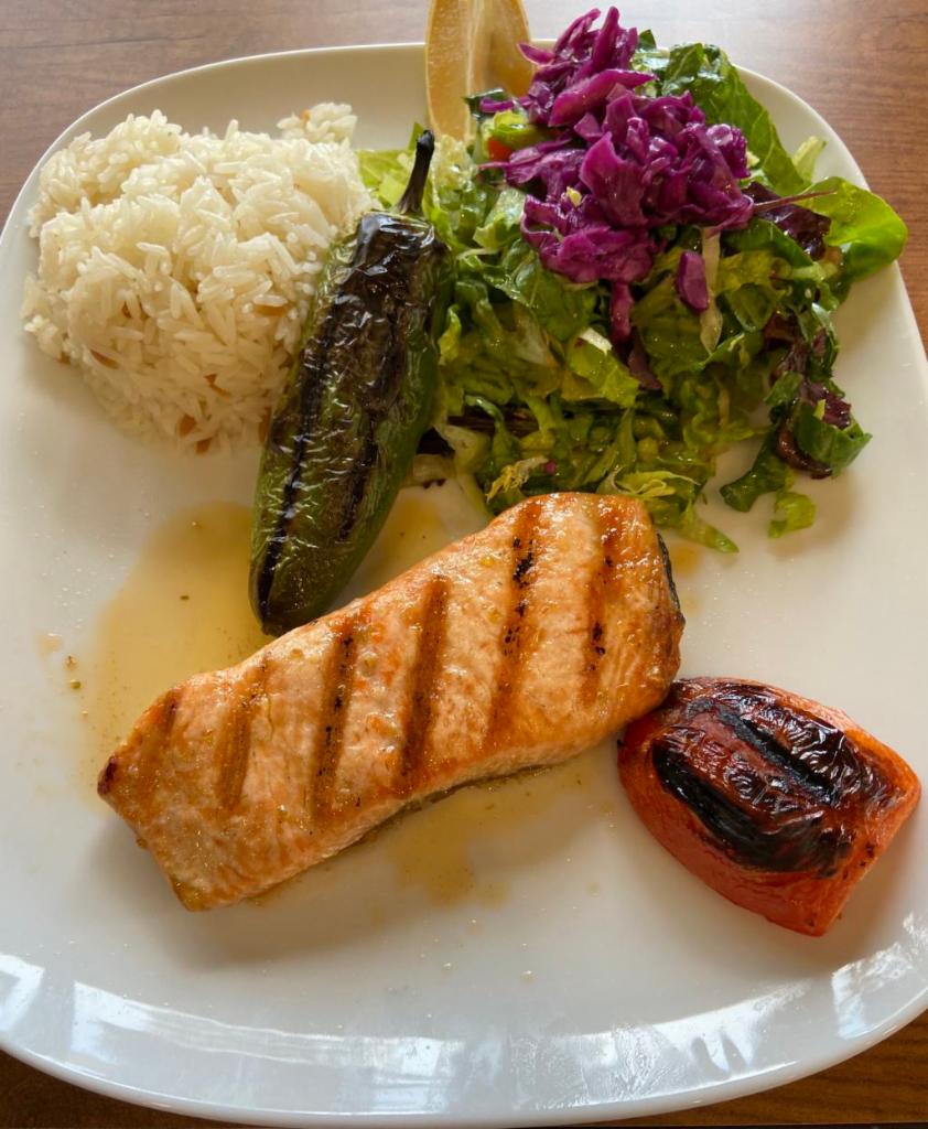 Grilled Salmon · Char-grilled salmon served with salad and rice.