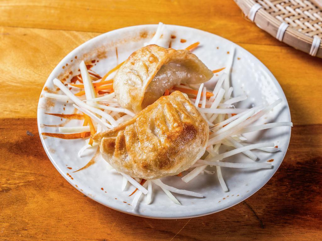 Fried Pork Dumplings (2 Pcs) · Made with pork, garlic, chives, soy sauce, sesame oil, and ginger. Served w/ spicy fish sauce vinaigrette on the side.