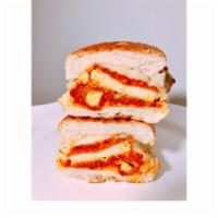 G4. Chicken Parmigiana · Breaded chicken cutlet, melted Mozzarella cheese, Parmesan cheese, and marinara sauce on a t...