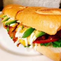 G5. Chicken Twister · Breaded chicken cutlet, American cheese, avocado, lettuce, tomato, and ranch dressing on a t...