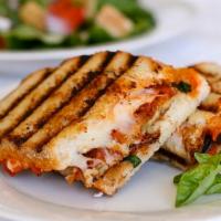 P1. Chicken Parmigiana Panini · Breaded chicken, fresh Mozzarella cheese, marinara sauce, and Parmesan cheese on European fl...