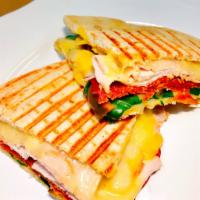 P11. Capri Panini · Smoked turkey, pepperoni, Provolone cheese, spinach, cherry pepper, and honey mustard on Eur...