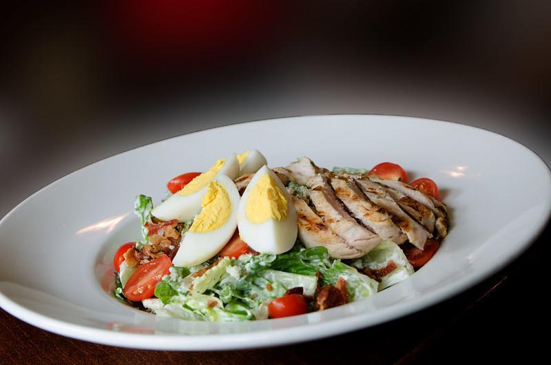 Cobb Salad · Grilled chicken, avocado, bacon, grape tomato, cucumber, hard boiled egg, and romaine lettuce.