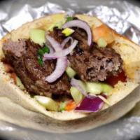 Kofta Kebab Sandwich · Comes with a container of mixed salad on the sided and pita bread.