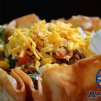 Deluxe Taco Salad · An Azteca favorite served with choice of ground beef, chicken or picadillo. Layered with let...