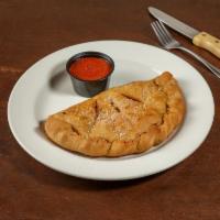 Steak and Cheese Calzone · Thinly sliced premium steak, mozzarella, red onions, and green peppers. Comes with a side of...