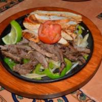 Combination Fajitas (Serves 2 People) · Choice of any two, beef, chicken or pork, served with Spanish rice, refried beans, pico de g...