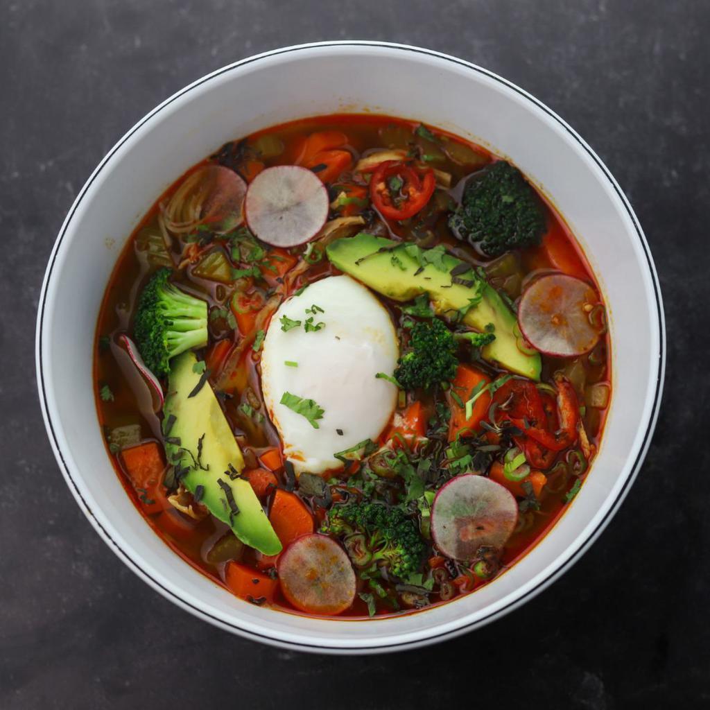 Spicy Chicken Noodle Soup · Red Chile Miso Broth, Rice Vermicelli Noodles, Slow Cooked Chicken, Mixed Veggies, Avocado, and Fried Egg 