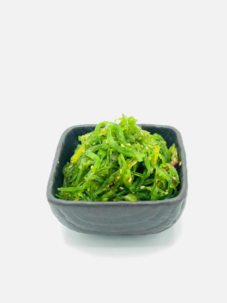 Seaweed Salad · Shiny translucent seaweed-tinted noodles, topped lightly with a tangy vinaigrette and sesame seeds.