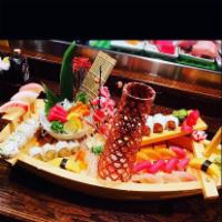 The Boat · 1 spicy tuna roll, 1 Shaggy dog roll, 16 pieces sushi, 6 pieces sashimi.