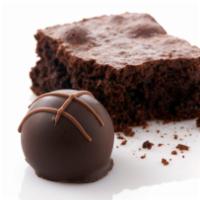 Brownie Bite · A layer of dark chocolate enrobes a dark chocolate ganache and a moist brownie