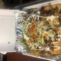 Nachos Beef · Fresh beef, fresh cheese, topped with beans, lettuce, pico de gallo, jalapenos, and sour cre...