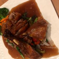 CR1. Tamarind Duck · Crispy 1/2 duck, snow pea, onion, scallion, and shredded ginger topped with tamarind sauces.