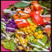 Rainbow Style Over Greens · Mixed greens topped with a mashed avocado, crisp red cabbage, roasted corn and fresh tomato,...