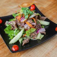 Beef Salad · Grilled marinated beef with spicy lime sauce, cucumber, onions, tomatoes, cilantro.