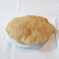 Bhatura · Fluffy, leavened bread kneaded into layers, deep-fried and served golden brown.