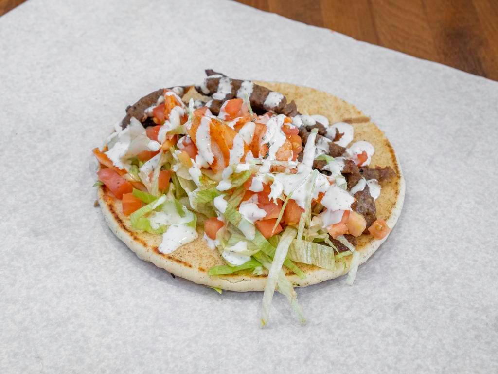 Gyro Wrap · Traditional lamb and beef gyro wrapped in pita bread along with your choice of 3 toppings.