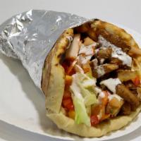 Chicken Shawarma Wrap · Juicy chicken shawarma cut off the donor and layered on top of thin bread, garlic sauce, tom...