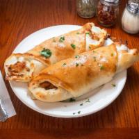 Pepperoni and Sausage Stromboli · Served with marinara sauce.