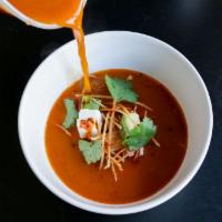 Sopa de Tortilla · Tomato and guajillo broth, avocado, queso fresco, fried tortilla.