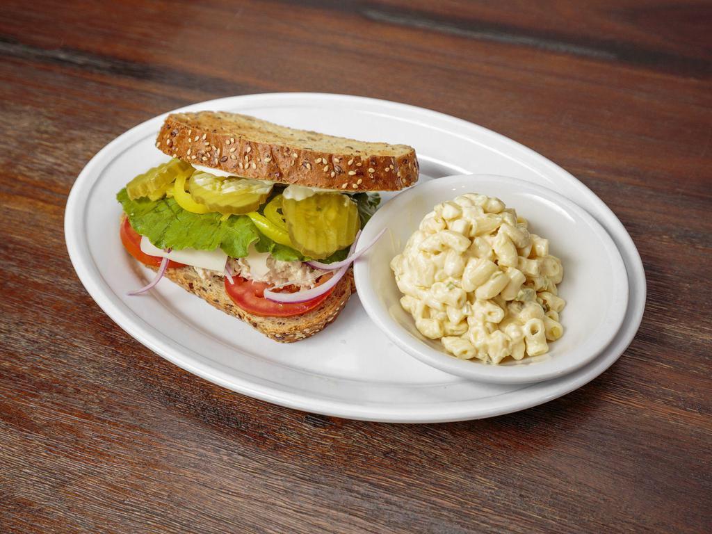 Tuna Salad Sandwich · Homemade tuna salad served with lettuce and tomato on sourdough bread.