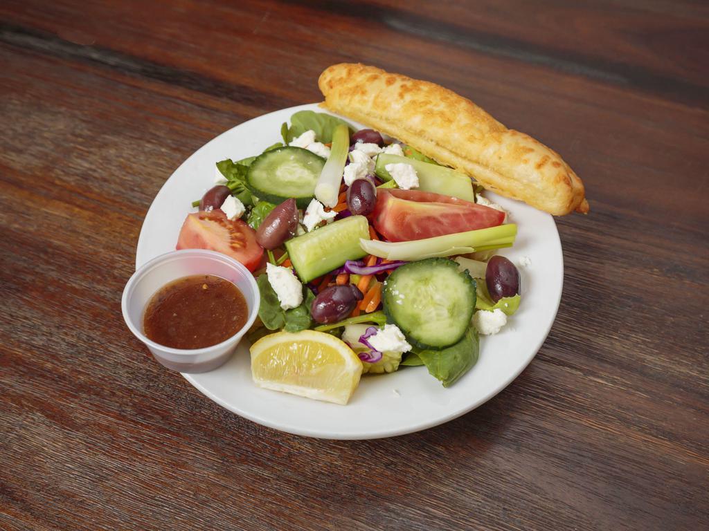 Greek Salad · Romaine, feta, tomato, red onion, cucumbers, Kalamata olives, and house vinaigrette.