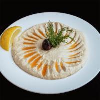 Hummus · Mashed chickpeas with lemon juice, olive oil, garlic and flavored. Served with tahini.