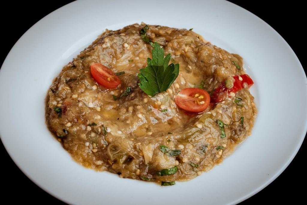 Eggplant Salad · Charcoal grilled eggplant, tomatoes, green and red peppers flavored. Served with garlic and herbs.