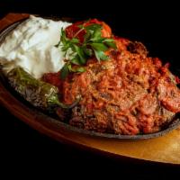 Iskender · Lamb gyro served over diced pita bread. Served with freshly made tomato sauce and yoghurt.