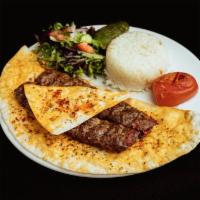 Lamb Adana Kebab · Ground lamb flavored with red bell peppers, slightly seasoned. Served with paprika and grill...