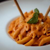 Penne A’la Vodka · Delicious penne pasta served with homemade recipe made vodka sauce topped. Served with Parme...