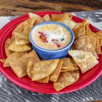 Chile con Queso · A creamy blend of chihuaha cheese, diced red bell peppers, garlic, diced onion and diced jal...