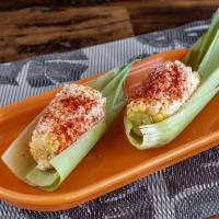 Elotes · A classic Mexican street corn on the Cobb roasted and coated with roasted garlic mayonnaise ...