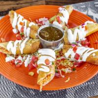 Flautas · 3 flour tortillas stuffed with tinga infused chicken and fried to a golden brown topped with...