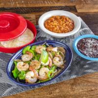 Shrimp Fajita · with red bell peppers, sauteed onions, roasted garlic served with sofrito rice, black beans,...