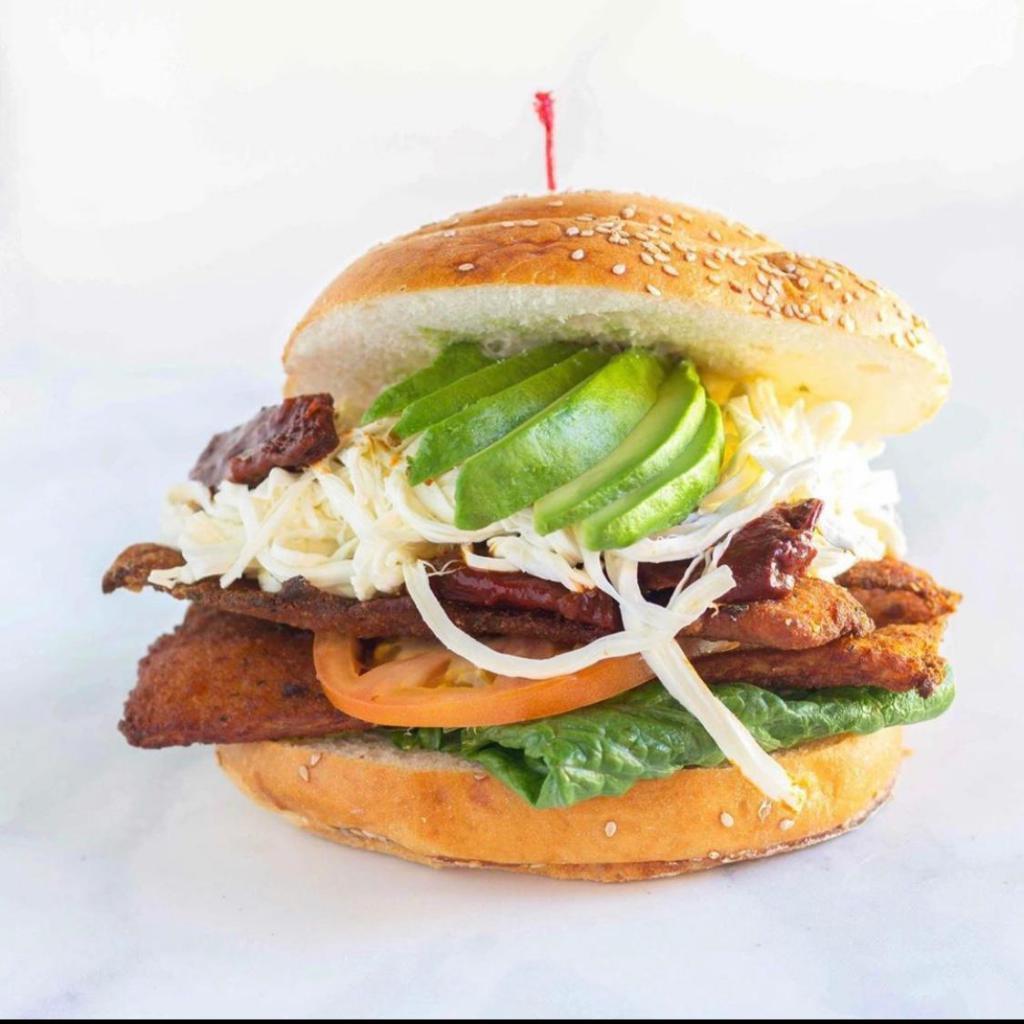 Milanesa de Pollo Cemita · Breaded chicken Juquila signature sandwich. Served with chipotle peppers, Oaxacan string cheese and papalo herb leaves with extra virgin olive oil.