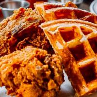 Classic Chicken ＆ Waffles · 2 bone-in pieces of fried chicken paired with a whole waffle. Served with hot sauce, maple s...