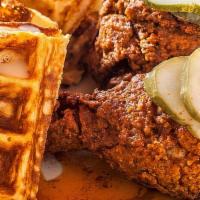 Nashville Hot Chicken ＆ Waffles · 2 spicy bone-in pieces of fried chicken paired with a whole waffle. Served with hot sauce, m...