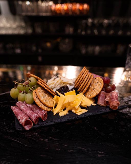 Charcuterie Board · Smoked Gouda, Manchego, Salami, Prosciutto, Fig Jam, Grapes
  **serves 2-3 people**