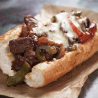 The Philly Cheesesteak · Sandwich with tiny strips of sliced beef steak, onions, and melted cheese on a hero roll.
