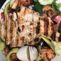 Cobb Salad · Grilled chicken breast, avocado, hardboiled egg, bacon, tomatoes, onions, and blue cheese cr...