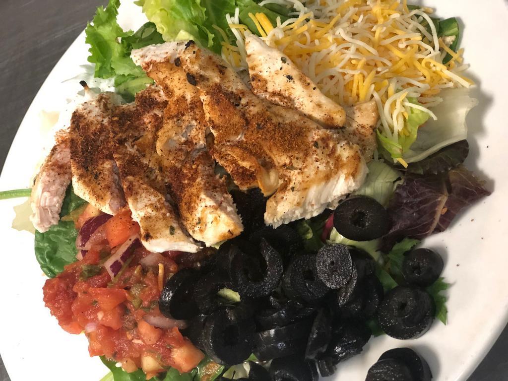 Mexican Chicken Salad · Blackened chicken, black olives, diced tomatoes, mix-cheddar blend, sour cream, and salsa.