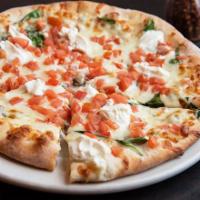 Tuscany Pizza · White pizza, spinach, ricotta cheese, and diced tomatoes.