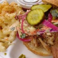 Pulled Pork Sandwich · Juicy, smoky pork dressed with your choice of condiments on a Brioche Bun.