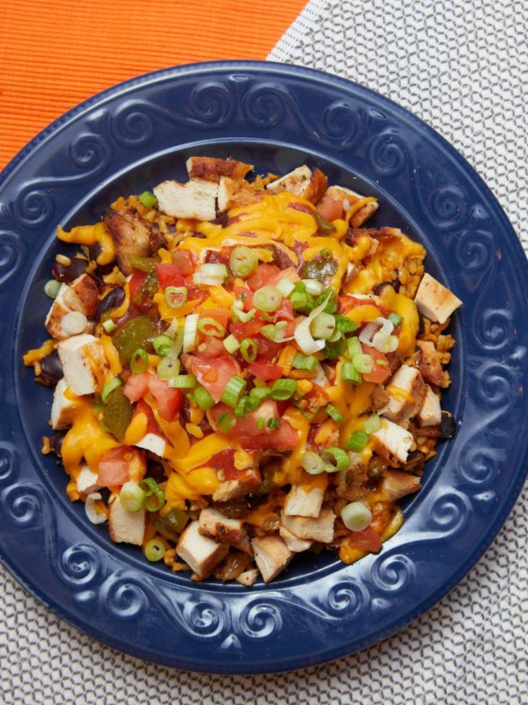 El Mexicana Bowl · Chicken or steak, sauteed green peppers and onions, reduced fat cheddar cheese, salsa, tomatoes, and scallions over brown rice and beans. Gluten free.