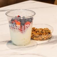 Yogurt Parfait · Yogurt with fresh strawberries, blueberries and granola with nuts.