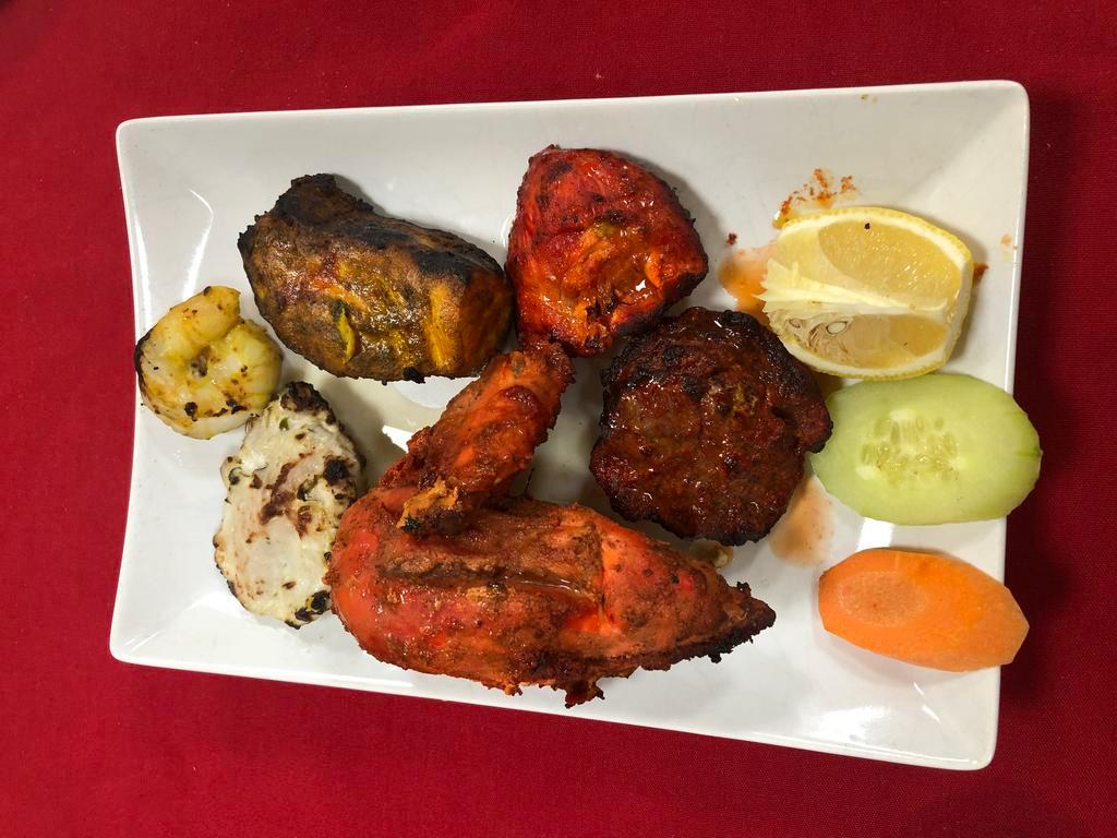 Mix Grilled Tandoori  · Assortment of Iamb, chicken, and seafood.